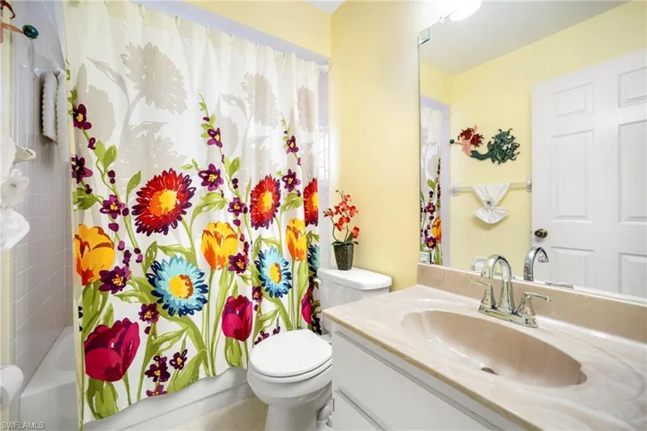 Full bath with vanity and shower / bath combo with shower curtain