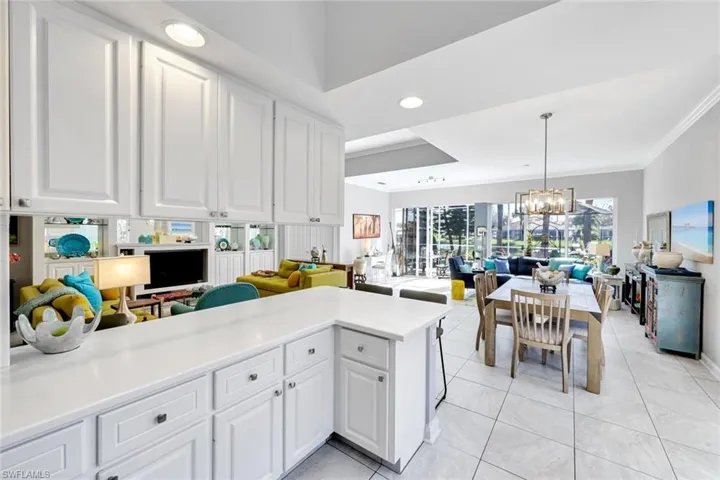 Kitchen featuring white cabinetry and light-toned countertops