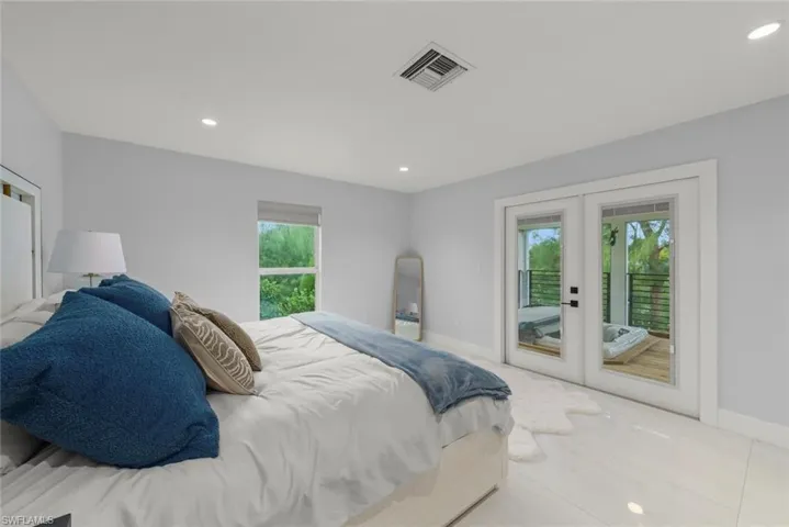 Bedroom featuring french doors, recessed lighting, access to exterior, and tile patterned floors