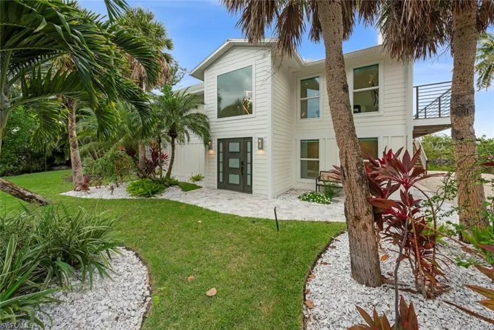 Back of house featuring a yard and a patio area