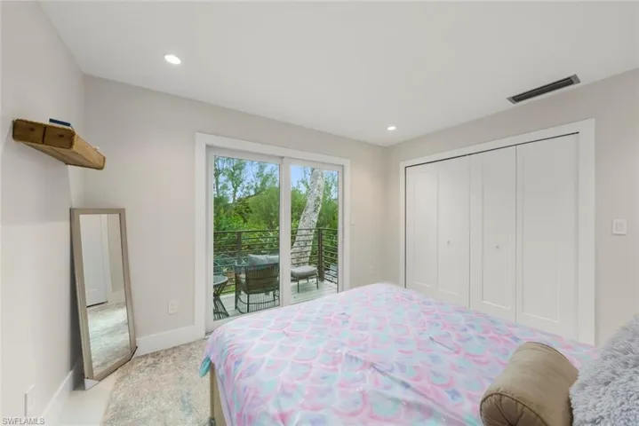 Bedroom with access to outside, a closet, carpet floors, and recessed lighting