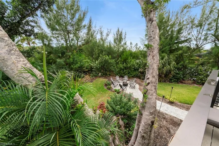 View of grassy yard featuring a patio area