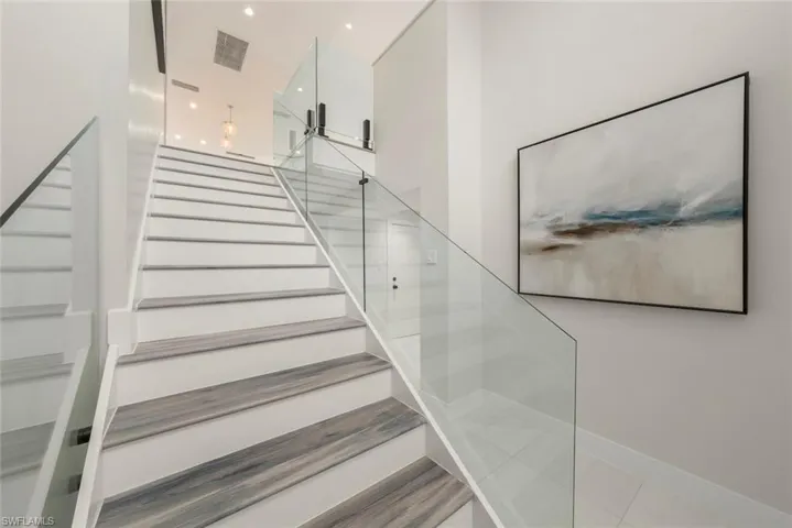 Staircase featuring recessed lighting and baseboards