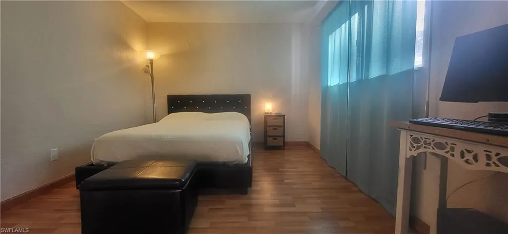 Bedroom featuring wood-type flooring
