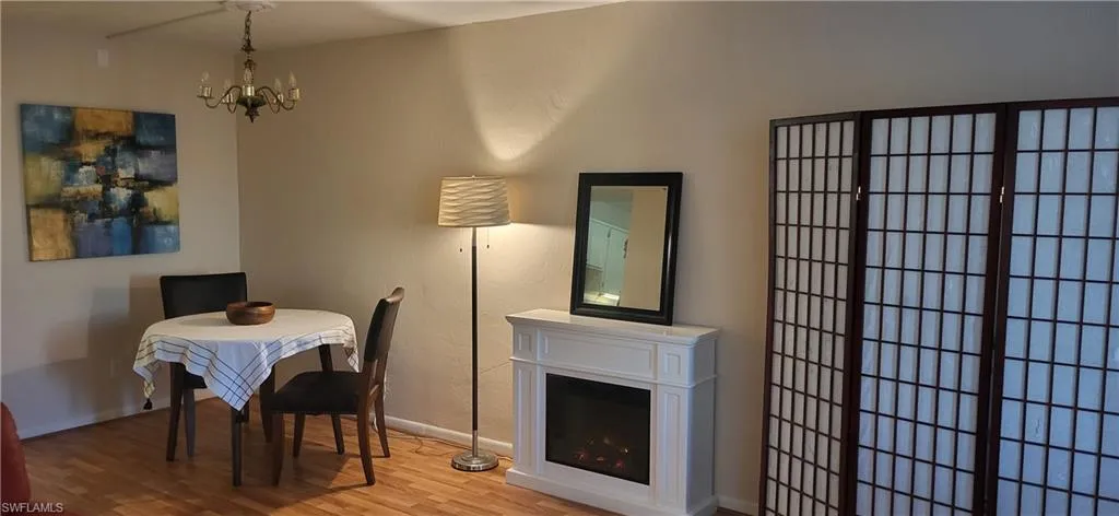 Dining space featuring hardwood / wood-style floors and an inviting chandelier