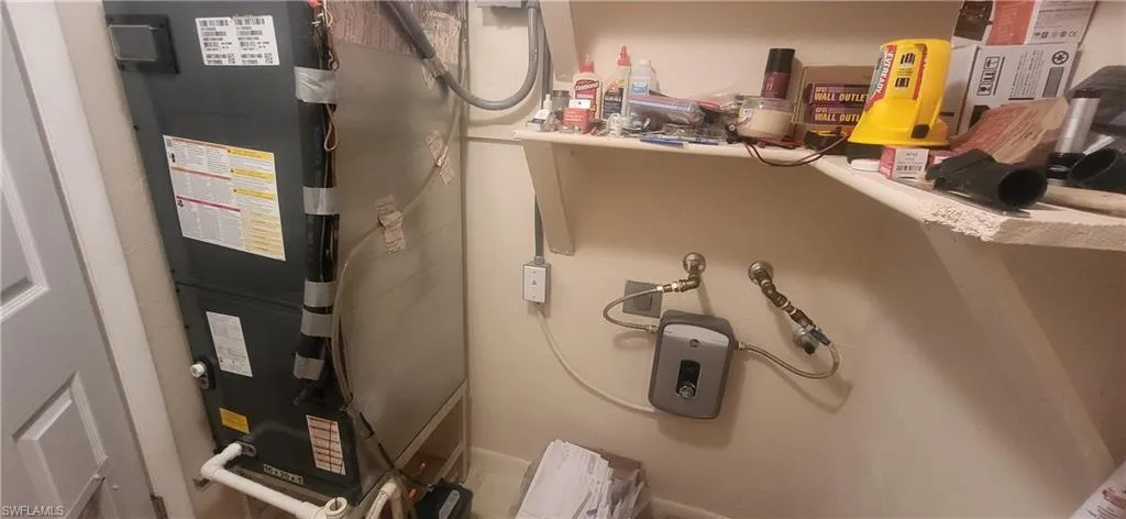 Utilities featuring heating unit tankless water heater room for dryer, also there is a laundry room in clubhouse