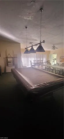 Rec room featuring carpet flooring, ceiling fan, and pool table
