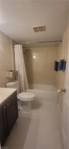 Bathroom featuring tile patterned flooring, vanity, and toilet
