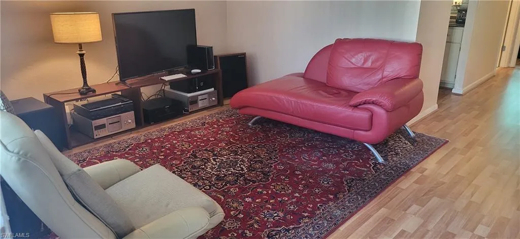 Living room with light hardwood / wood-style floors