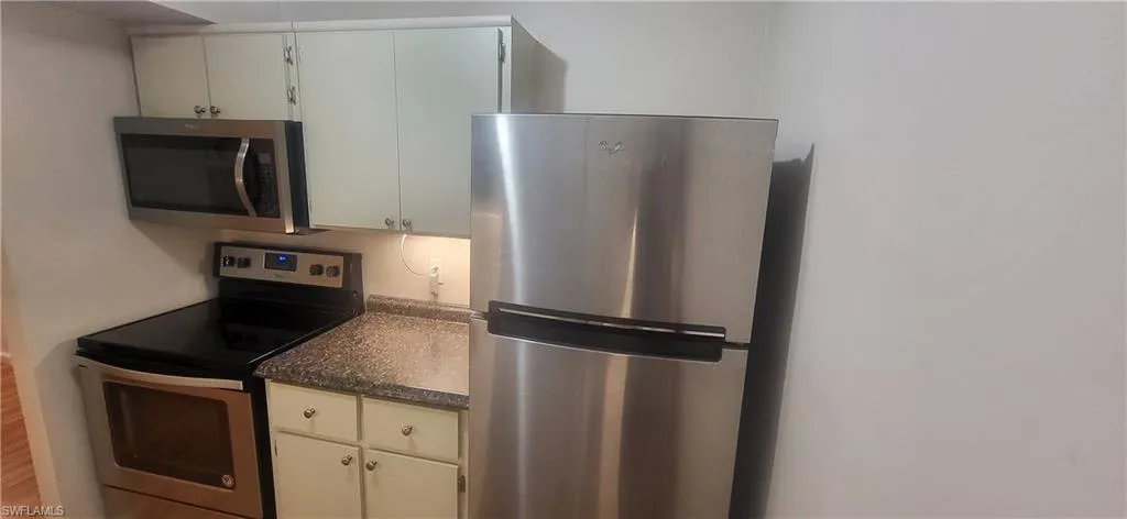 Kitchen featuring stainless steel appliances and hardwood / wood-style flooring