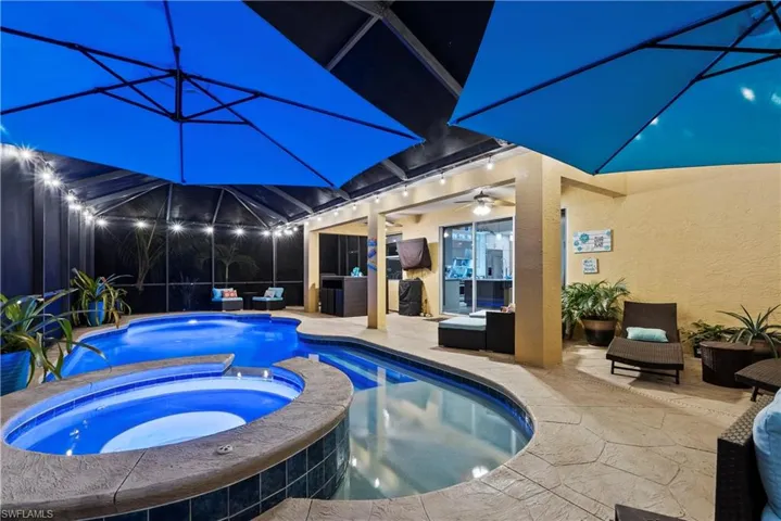 View of pool with an in ground hot tub, ceiling fan, outdoor lounge area, and a patio