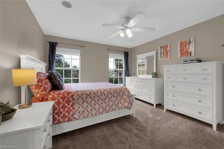 Bedroom featuring ceiling fan and dark carpet