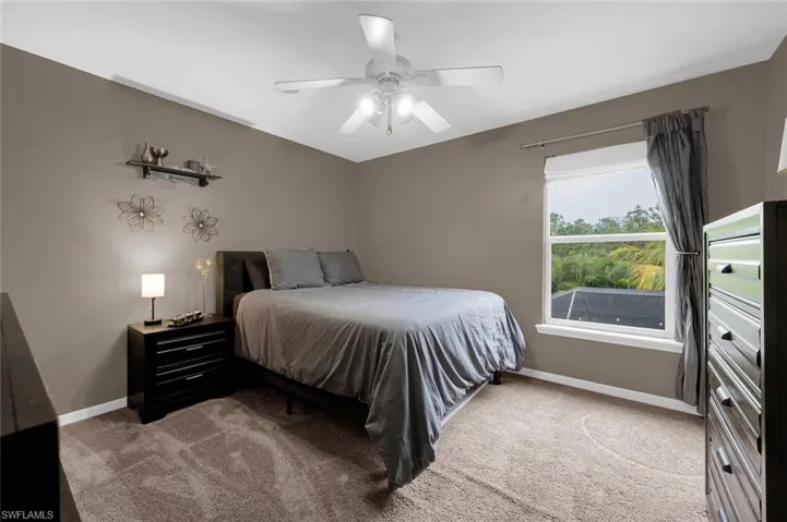 Carpeted bedroom with ceiling fan