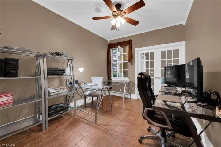 Office with crown molding, hardwood / wood-style flooring, ceiling fan, and french doors