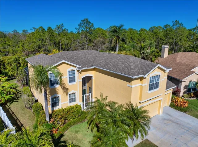 Mediterranean / spanish-style house featuring a garage and a front lawn