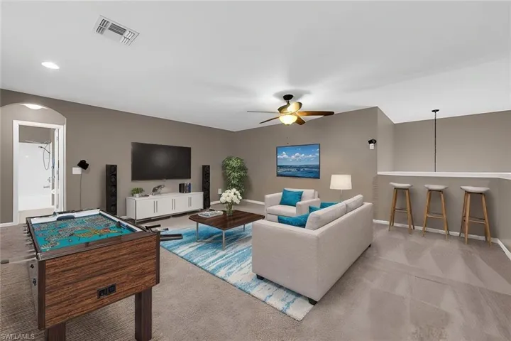 Carpeted loft/game room/extra living room with ceiling fan