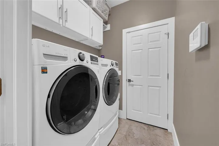 Washroom with independent washer and dryer and cabinets