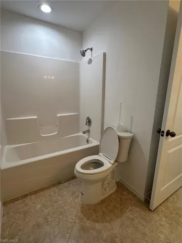 Full bathroom featuring  shower combination and light tile patterned flooring