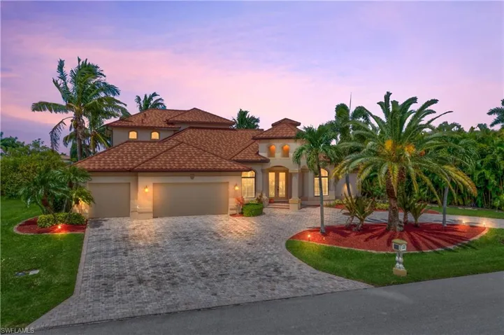 Mediterranean / spanish house featuring a yard and a garage
