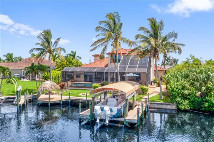 Dock area featuring a yard, a lanai, and a water view