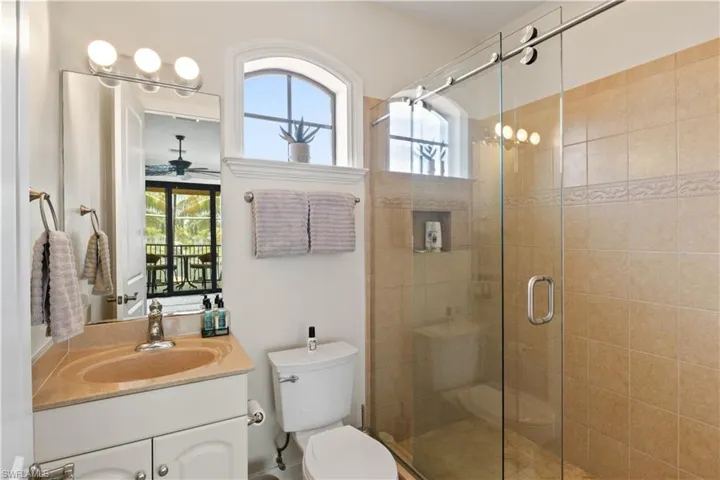 2nd floor bathroom featuring ceiling fan, a wealth of natural light, toilet, and vanity