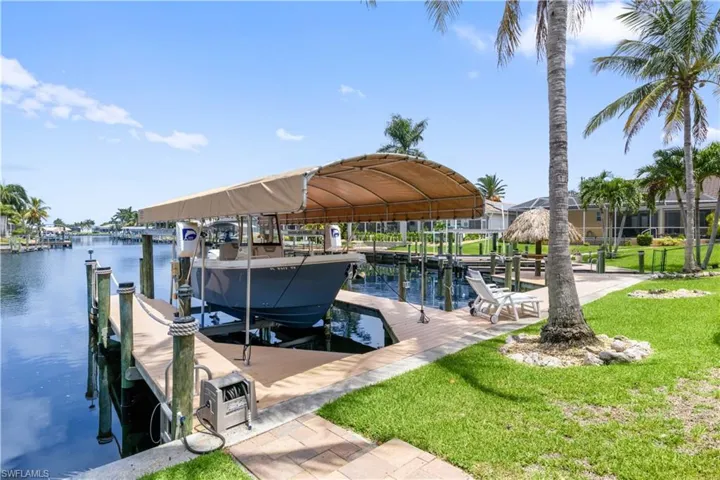 Dock area featuring a yard and a water view