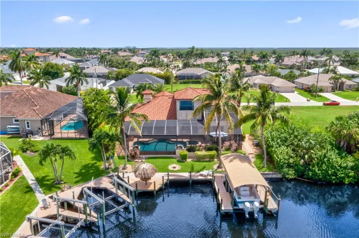 Birds eye view of property with a water view