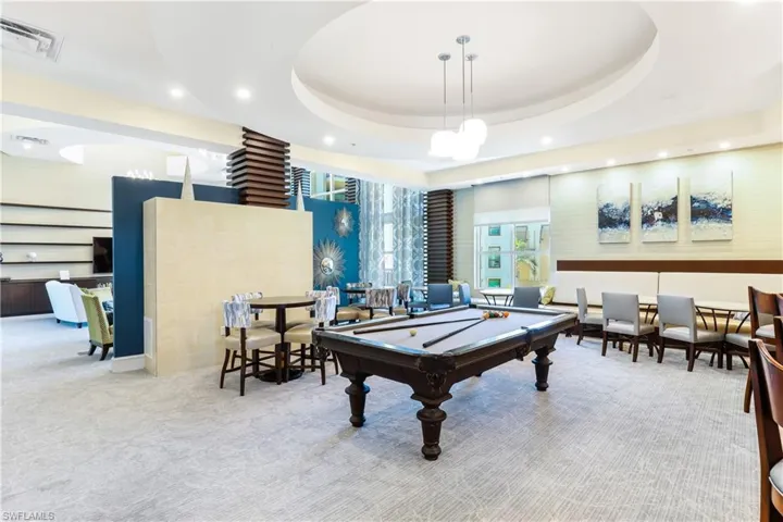 Game room featuring a tray ceiling, pool table, and carpet