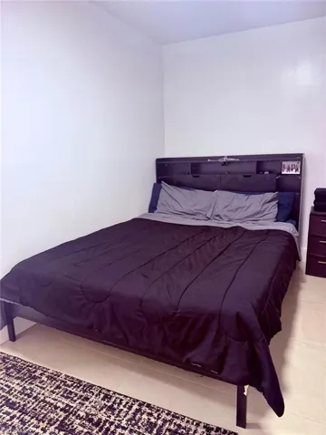 Bedroom with light tile patterned flooring
