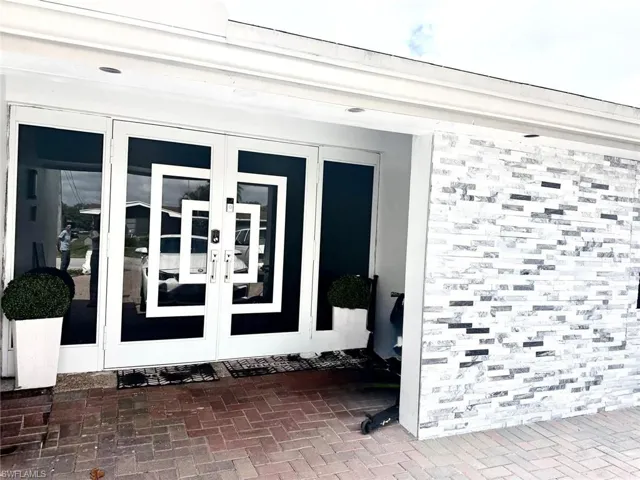 Property entrance featuring french doors