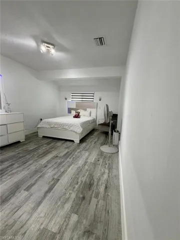 Bedroom featuring light wood-style floors and baseboards