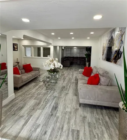 Living area featuring light wood-type flooring and recessed lighting