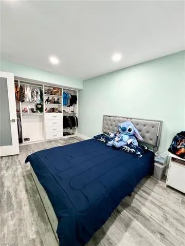 Bedroom featuring light wood-style flooring and a closet