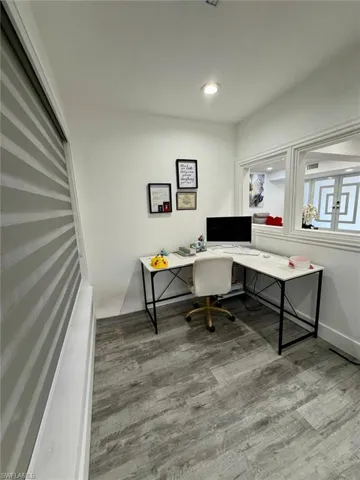 Home office with wood finished floors and recessed lighting
