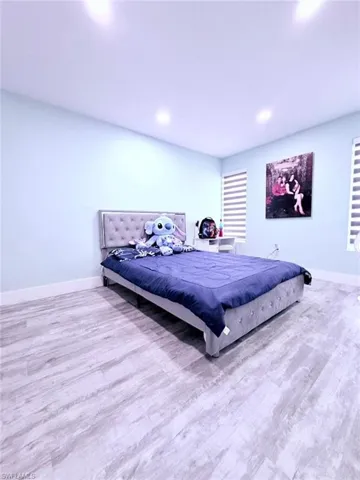 Bedroom featuring light wood-type flooring and recessed lighting
