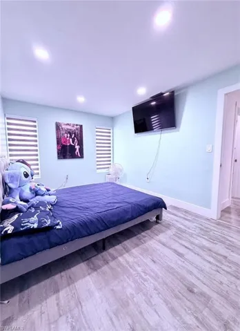 Bedroom featuring light wood-type flooring and recessed lighting