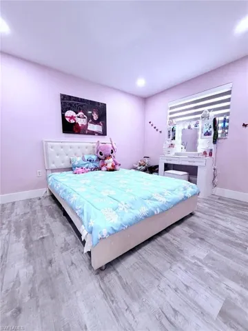 Bedroom with light wood-style flooring and recessed lighting