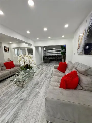 Living room featuring light wood-style flooring and recessed lighting