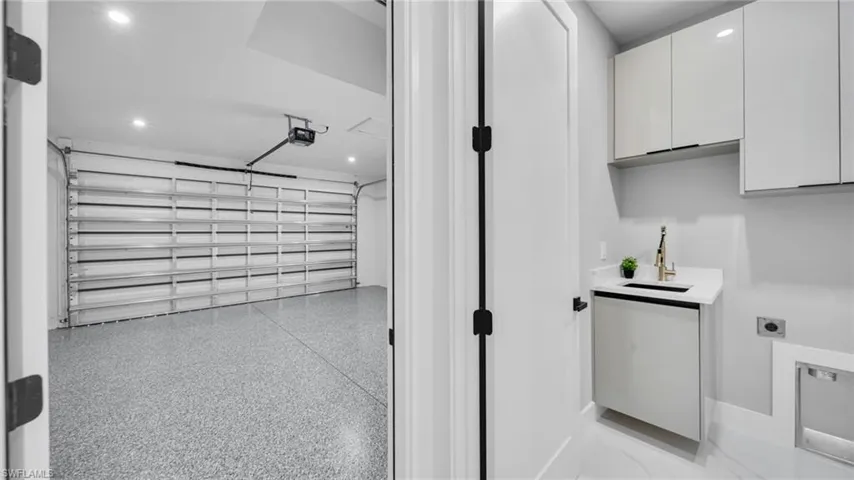 Garage with a sink and recessed lighting