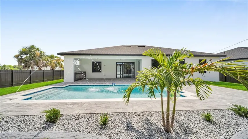 Back of house featuring a patio, a fenced backyard, stucco siding, and a shingled roof