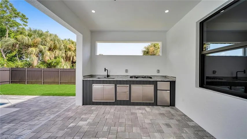 View of patio / terrace with exterior kitchen and a sink