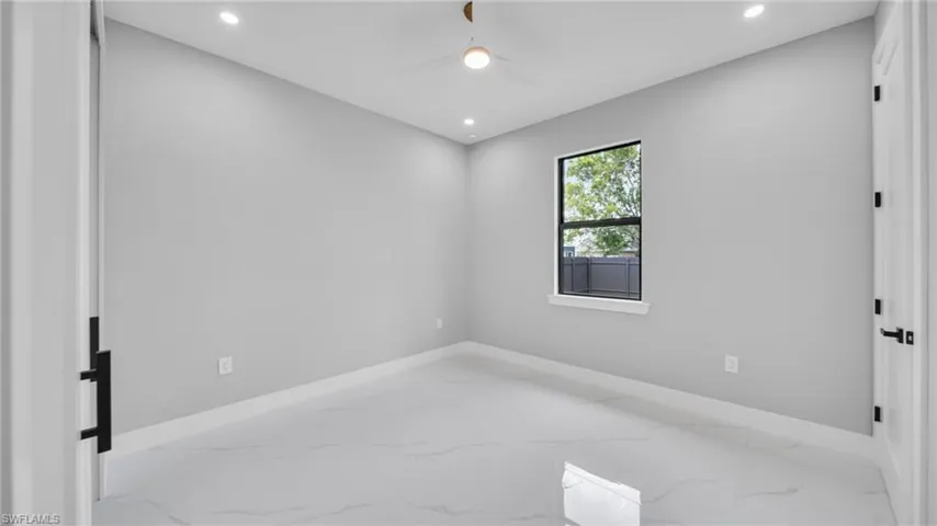 Unfurnished room with marble finish flooring, recessed lighting, and ceiling fan