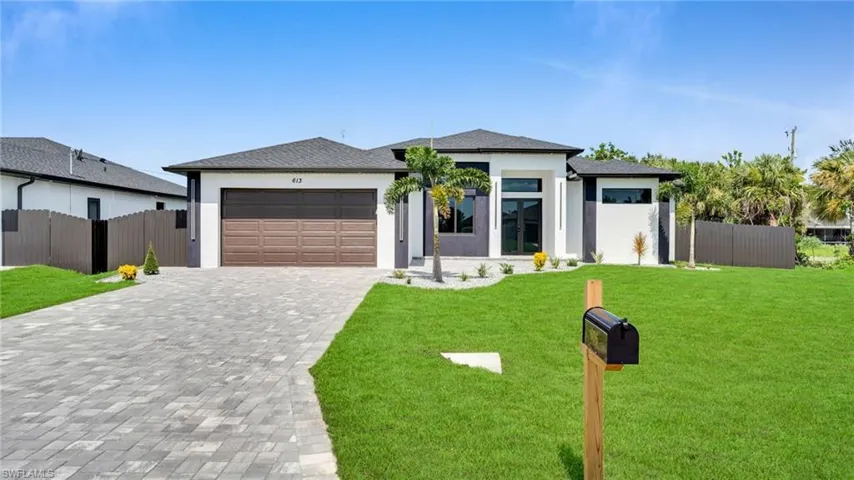 Prairie-style home featuring an attached garage, decorative driveway, stucco siding, and a shingled roof