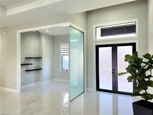 Entryway featuring french doors and baseboards