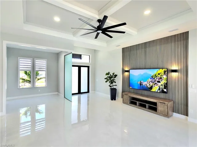 Home theater with recessed lighting, a ceiling fan, coffered ceiling, beamed ceiling, and baseboards