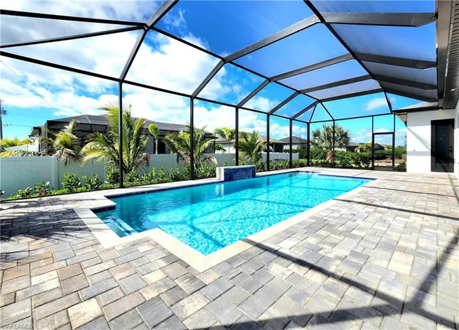 Outdoor pool featuring a patio and glass enclosure