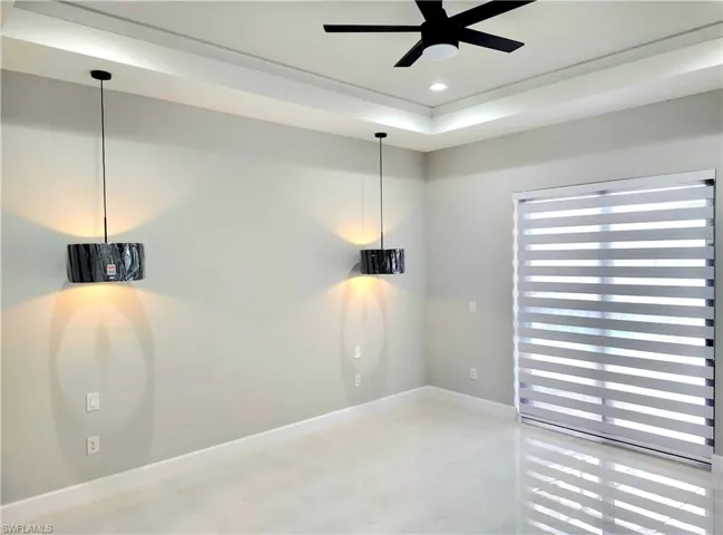 Unfurnished room with ceiling fan, recessed lighting, concrete flooring, and baseboards
