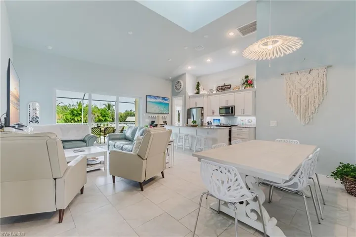 Open-concept living space featuring high ceilings and light tile flooring