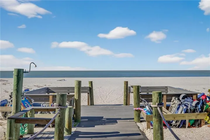 Boardwalk to beach where residents gather for cocktails at sunset.