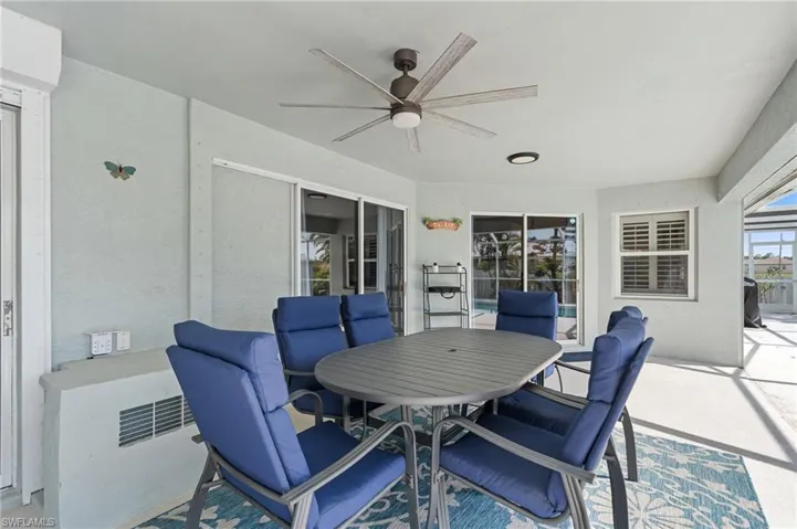 View of patio featuring outdoor dining space and a ceiling fan